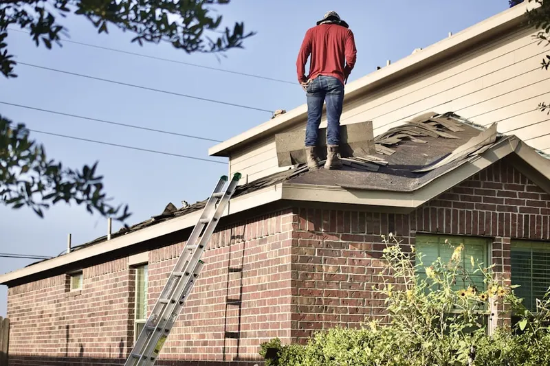 Professional roofer working on a residential roof in Hickory Woods